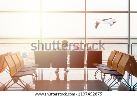 Man passenger are waiting on seat in gate terminal for flight departure