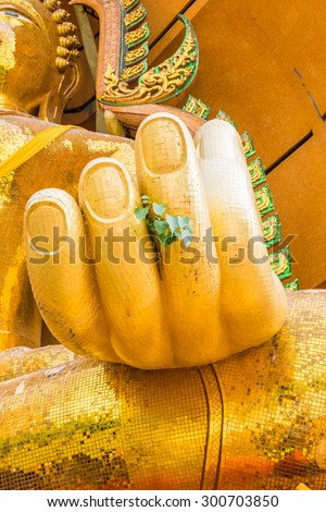 Gold hand big buddha statue bodhi tree leaves in wat tham sua temple , tha moung, kanchanaburi, thailand
