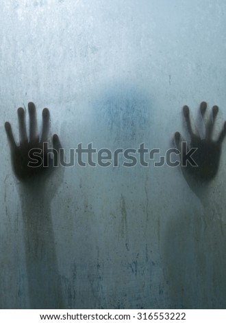Hand person shadow behind translucent mirror stain