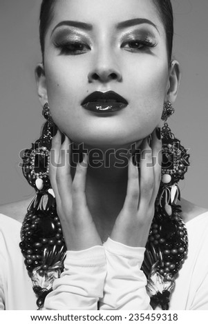 Portrait of amazing woman. Perfect bright makeup. Closeup. Asian girl with earrings. B/W