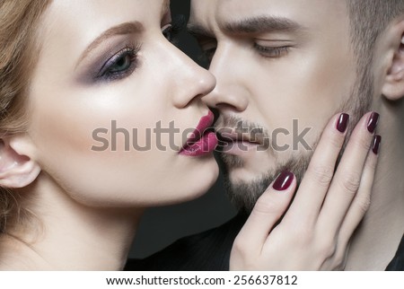 Passionate couple. Beautiful young man and blond woman closeup. Woman hugging a man.Woman hugging man. Love. Flirt. Kiss. Lovers.  Portrait of beauty blond girl and her handsome boyfriend.