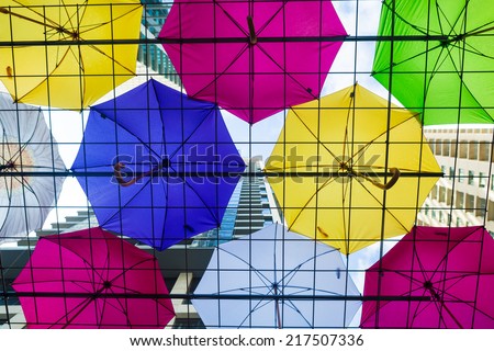 SYDNEY, AUSTRALIA - SEPTEMBER 14, 2014: Many umbrellas are at World Square to protect people from the winter rain.  World Square is a large development in Sydney central district business.