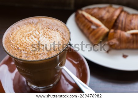 Coffee and ham and cheese croissant
