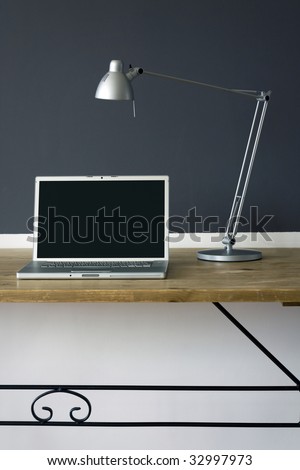 frontal Home office desk with laptop and printer