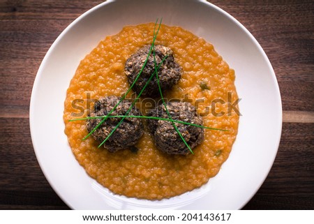 Healthy dish with beef and buckwheat flakes meatballs and side dish of red lentil with garlic and curcuma.