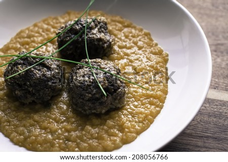Healthy dish with beef and buckwheat flakes meatballs and side dish of red lentil with garlic and curcuma.