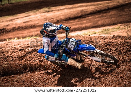 Biker accelerating in a motocross dirt track