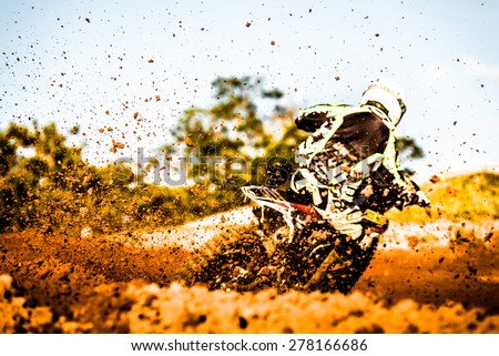 Details of flying debris during an acceleration in a motocross dirt track