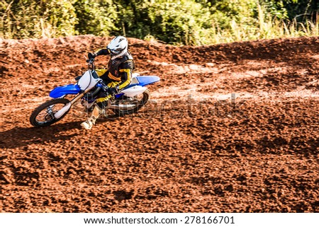 Fast motorcycle racer in dirt track