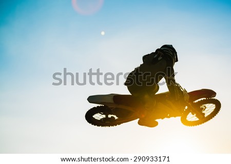 Motocross Rider Jump at Sunset