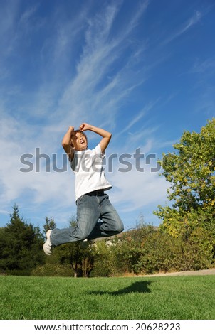 Boy expressing happiness by jumping in the park