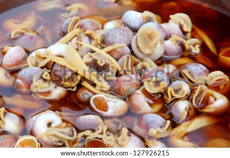 Shanghai, China cuisine: Live snails being immersed in yellow rice wine
