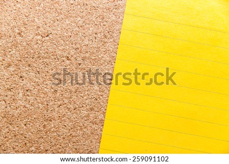 Line yellow sticky note on cork board with filled text blank space