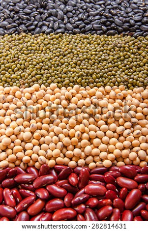 Top view background of different varieties of beans: red kidney beans, soybeans, mung beans, black beans