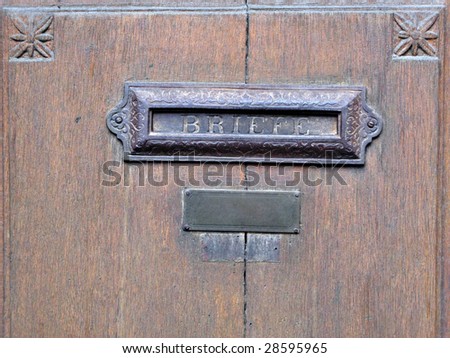 Antiquarian mailbox decoration plate on the old townhouse door