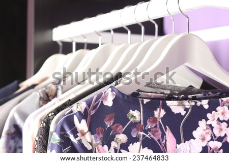 Female clothes collection on hangers in fashion boutique store