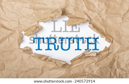 Truth and lie words on white paper with copy space and torn cardboard