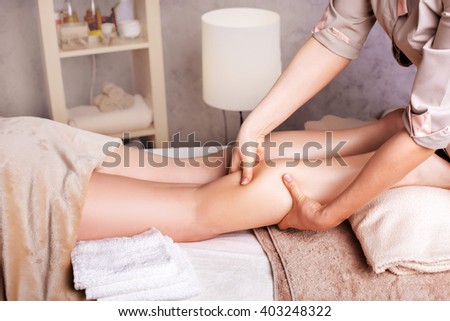 Woman having  rejuvenating foot massage for athletes, in Spa Salon
