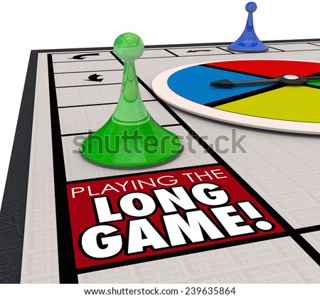 A player moving a game piece around the board to land on a square marked Playing the Long Game to illustrate investing for the long term future for better returns and winning in life