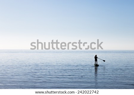 Paddle-boarding on open water.