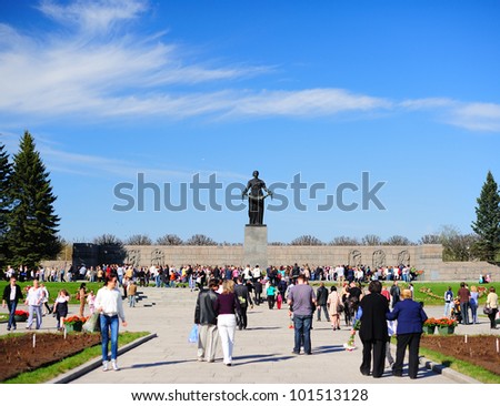 SAINT-PETERSBURG, RUSSIA - MAY 9: On Victory day people came to honor the memory of the buried soldiers on Piskaryovskoye Memorial Cemetery on May 9, 2011 in Saint-Petersburg, Russia