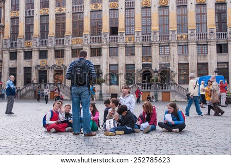 The Grand Palace of Brussels, Belgium - June 25,2013 : Teacher and children on a field trip