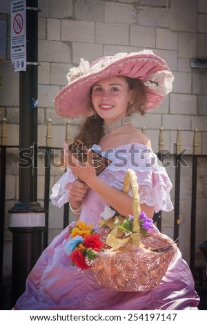 Windsor castle, England - June 30, 2013 : A pretty girl giving cards and flowers