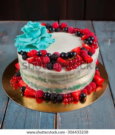 Cake with fresh berries and gum paste flower