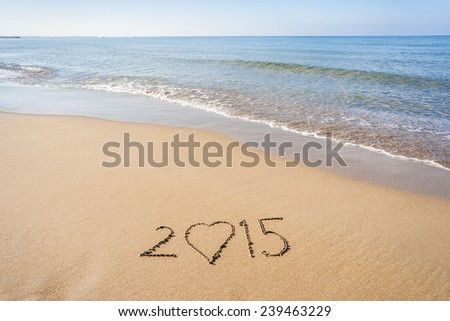 New Year 2015 written in the sand on the beach.