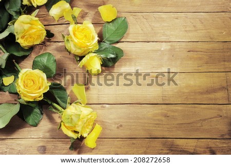 Love background with copy space - Yellow roses on wooden rustic background