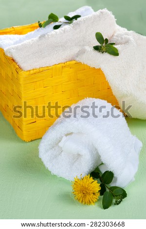 Stack and rolls of towels flowers