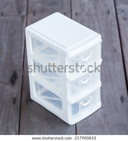 mini storage plastic box for office on wood background