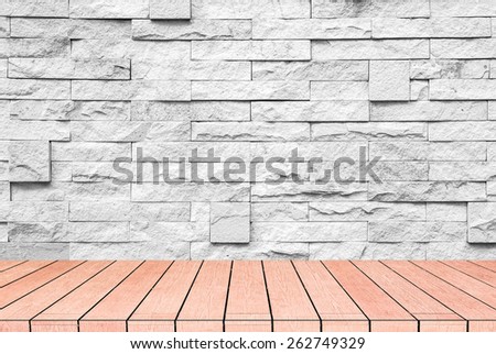 textured grey brick and stone wall with warm brown wooden floor inside old neglected and deserted interior, masonry and carpentry brickwork concept