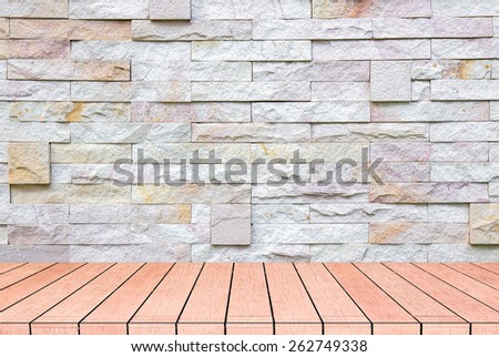 textured grey brick and stone wall with warm brown wooden floor inside old neglected and deserted interior, masonry and carpentry brickwork concept