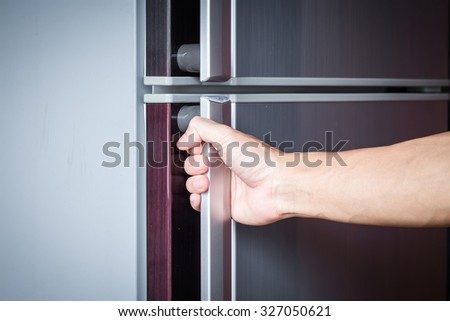 Abstract hand a young man catch a refrigerator door