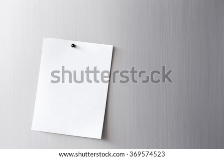 Empty paper sheet on refrigerator door. paper note with magnet