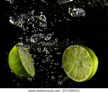 Lime falling in water, lime in the fall, collision with lime water (on a black background)