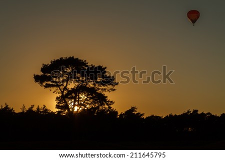 Air balloon gives balance to this beautiful silhouette sunset