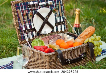 A picnic basket with food and champagne