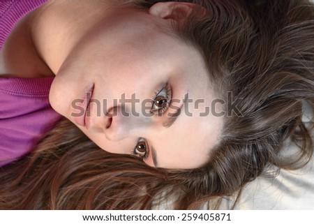 Girl shot from above with loose hair and proud look