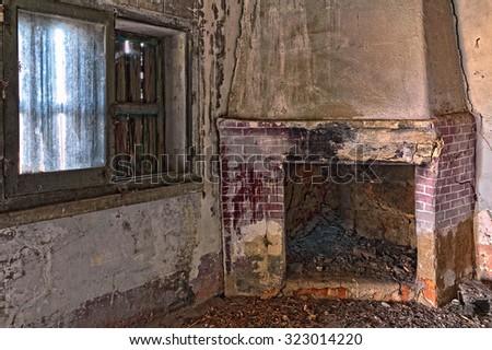 image of an old abandoned room with fireplace and window