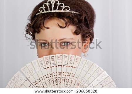 Portrait of a lady hiding behind fan, Empire style