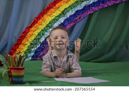portrait of a beautiful baby with blue eyes against a bright rainbow