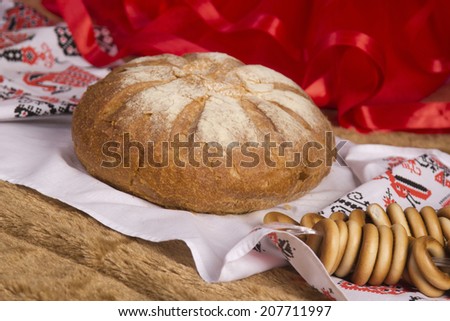 festive bread on an embroidered towel with bagels, Slavic folk style