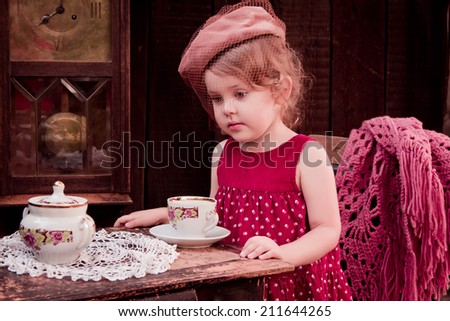 Portrait of a little lady in a hat with a veil, morning tea, retro, vintage