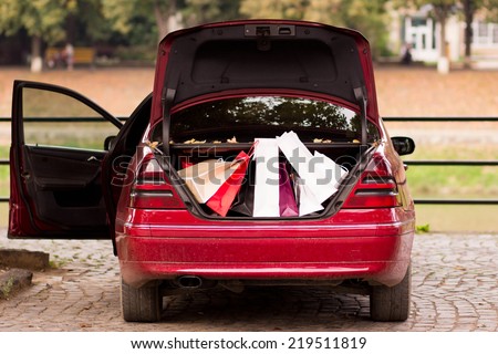 Open the trunk of the car with bags of purchases. Autumn sales, shopping