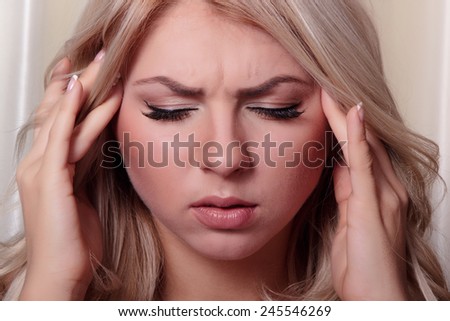 Headache, migraine and stress. Worried woman upset woman suffering from head pain
