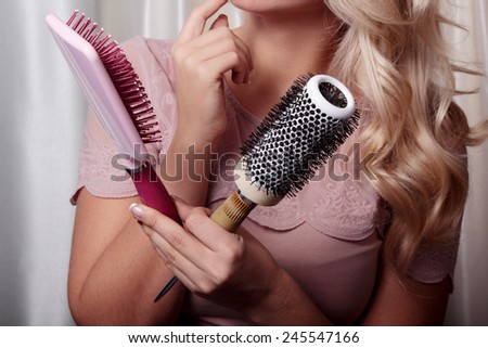 Professional combs in the hands of a woman barber. Choosing the right comb for hair styles