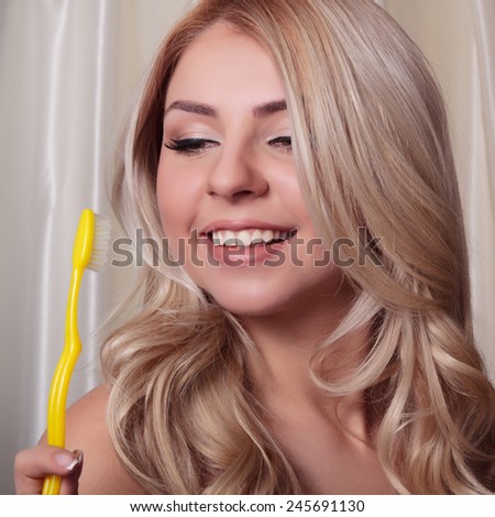 The teeth of a young woman closeup with toothbrush. Brushing teeth, health