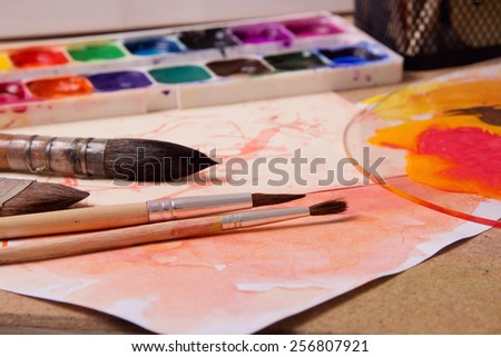 paints, brushes, a white sheet - a table of the artist, student